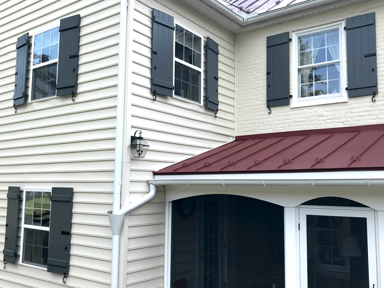 custom exterior shutters on historic farmhouse renovation