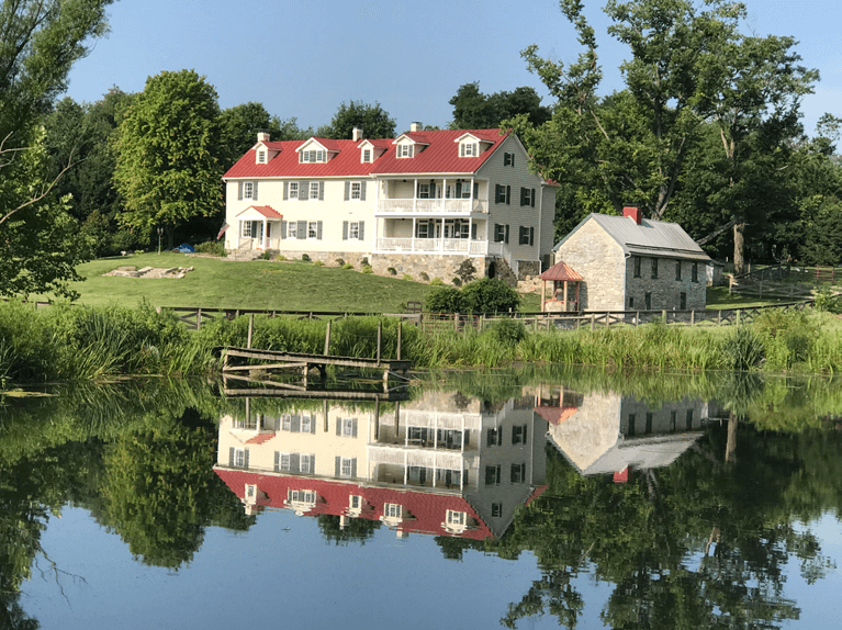 historic farmhouse renovation with custom exterior shutters