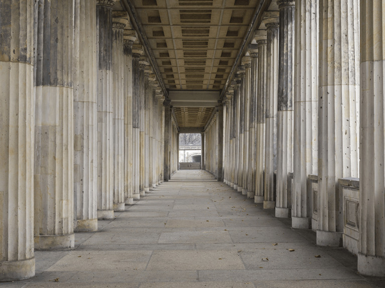 point of view of a hallway lined with symmetrically positioned columns