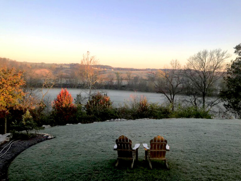 relaxing landscape view of an 80-acre farmstead with 2 wooden chairs