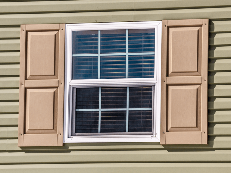 fixed mounted vinyl shutters on a house with vinyl siding