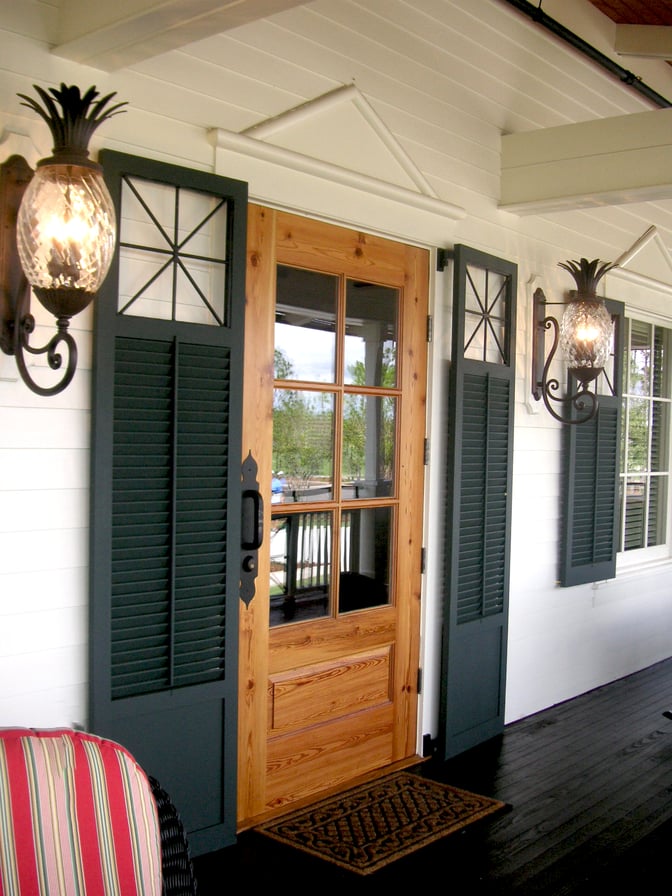 HBC picture - black panel and louver combination shutters with custom cutout white siding house front porch door