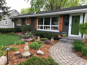 Stained wood panel shutters on dark blue home