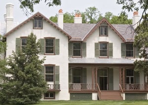 green louver shutters on white stucco Lincoln Cottage