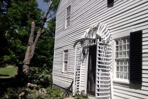 photo of home after tree fell on house damaging shutters