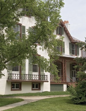 green louver shutters on white Lincoln Cottage