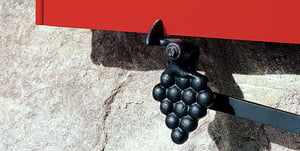 Vintage Grape Tieback on red shutter on stone home