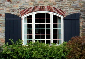 These arch top board and batten shutters are custom designed to fit the large window, while keeping a rustic, relaxed tone that is in line with the style of the homeowner. 