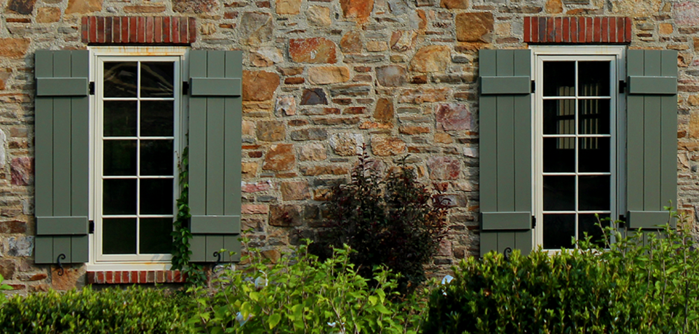 Green Timberlane Board and Batten Exterior Shutters on tan stone home