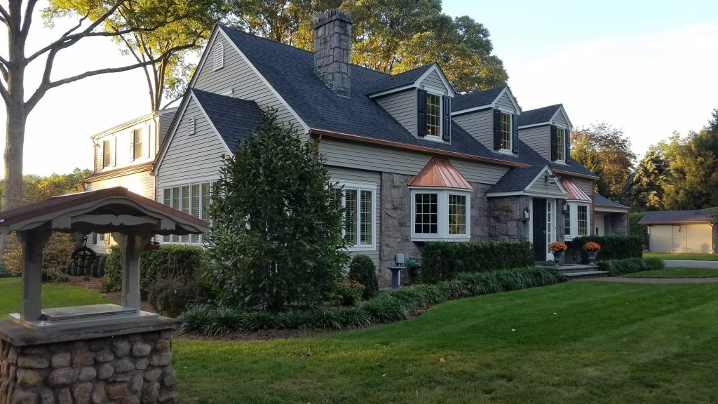 Cape Cod with copper details and functional exterior shutters