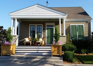 Green bermuda shutters on tan home