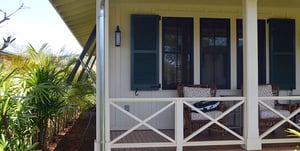 Blue Louvered Shutters on white beach home in Hawaii