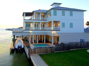 Teal bermuda shutters on white beach house