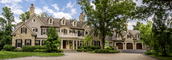 Custom blue panel shutters on tan stone home