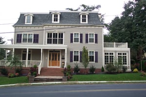 Purple louvers on gray home