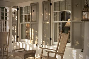 acorn cut outs on gray panel shutters on porch