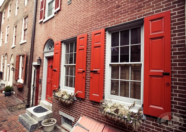 red panel shutters on brick home in elfreths alley, philadelphia Pennsylvania