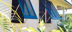 blue bahama shutters on white beach home