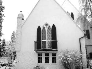 black louver arch top shutters on white church