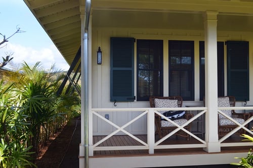 blue exterior shutters installed on beach cottage bungalow, both louver and Bermuda