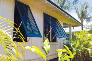 blue bermuda shutters on beach house bungalow