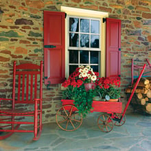 Red Panel endurian shutters on stone home