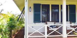 blue louver shutters on white wood beach home