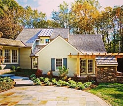 bLUE PANEL SHUTTERS ON GRAY HOME