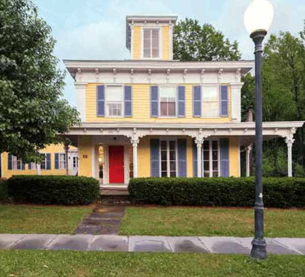 Italianate house with porch and louvered shutters