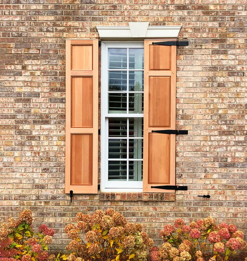 JVC wood panel shutters tan brick house single window social edit
