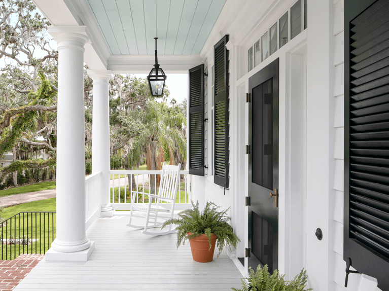 front porch with exterior shutters designed by florida custom builder nautilus homes