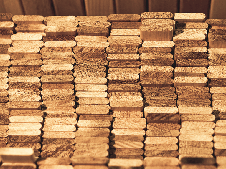 stacks of raw premium wood to handcraft Timberlane custom exterior shutters