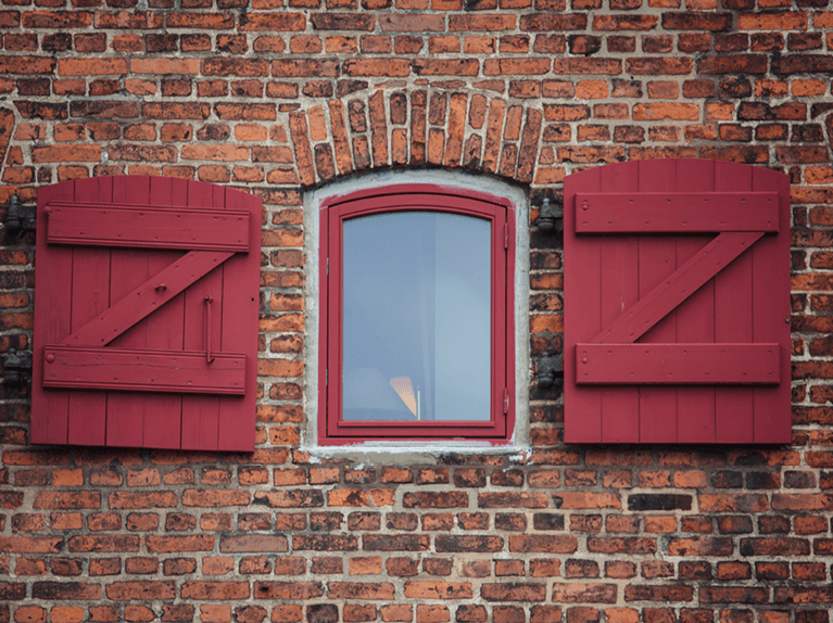 incorrectly sized z brace board and batten shutters on brick home