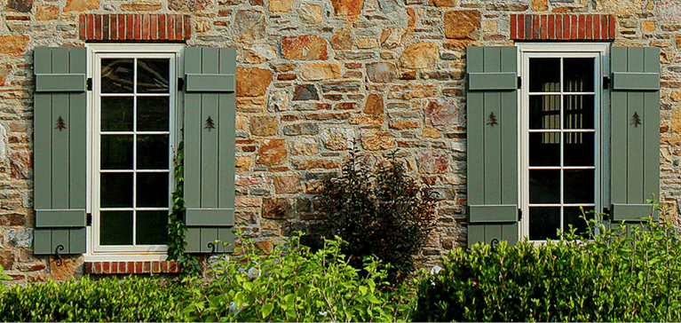 how exterior shutters give a stone home a rustic look