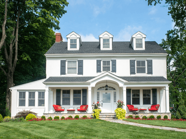 blue custom panel shutters for the exterior of a stucco home