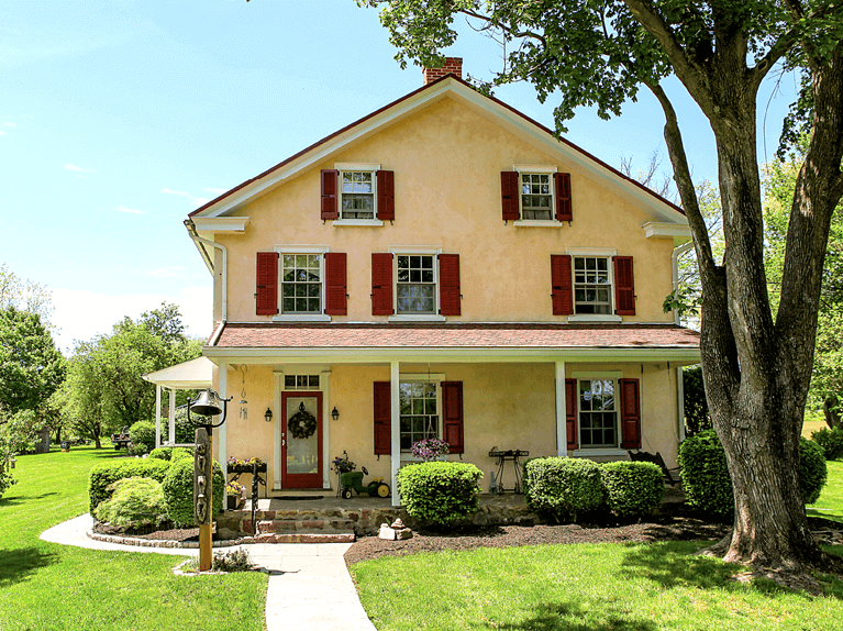 mahogany wood exterior shutters for a stucco home