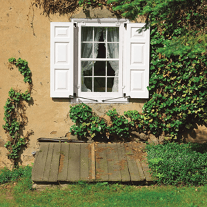 white panel shutters on yellow stucco home