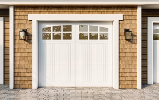 white 308 garage door on wood shakes garage front cropped